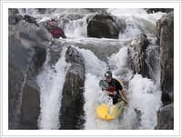 Two kayakers running the Falls