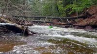 Jim McHale ducks two trees and boofs two on the Lower Carp, 221 cfs