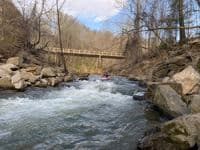 Hand paddling through the old dam site below Pond Road