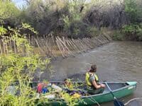pole fence in river