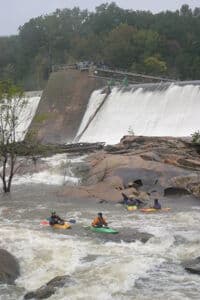 A crowd watches from the dam. 