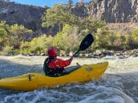 Peeling out of mid-rapid pocket eddy along wall