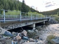 Take out before this bridge. 